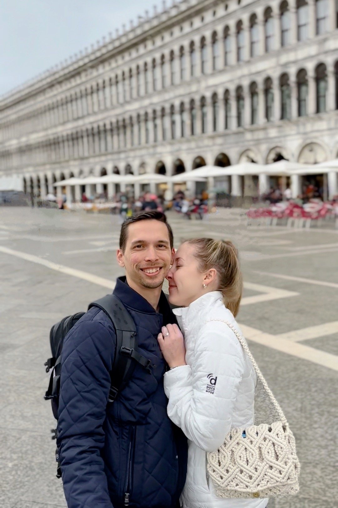 Josh and Hallie embracing in a Venice plaza